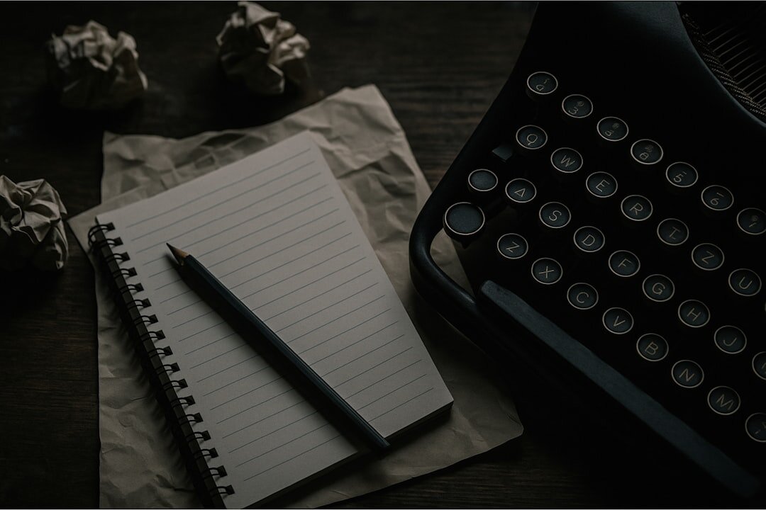 Person writing in a journal at a wooden desk